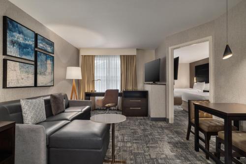 a hotel room with a couch and a bed at Residence Inn by Marriott Long Island Islip/Courthouse Complex in Central Islip