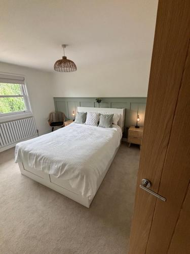 a bedroom with a large white bed and a window at 3 Bed home in Lincolnshire in Wigtoft