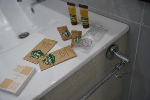 a bathroom sink with toiletries on top of it at La Maison di Donna Elena in Cercola