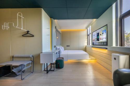 a hospital room with a bed and a sink at Atour X Hotel Beijing Wangjing 798 in Beijing