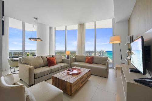 a living room with a couch and a table at Beautiful Beachfront Penthouse in Hollywood