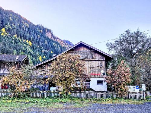 a wooden house with a fence in front of it at Apartment Haflingerhof Edelweiß by Interhome in Kaunertal