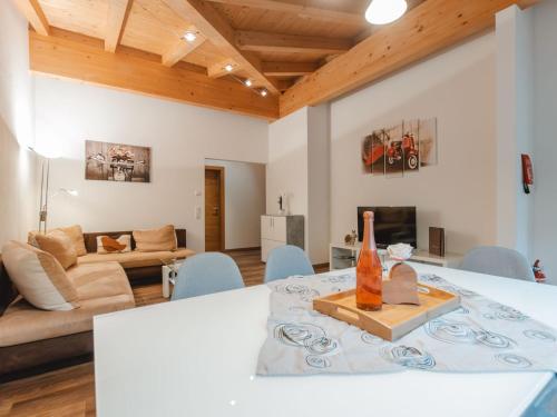 a living room with a table and a couch at Apartment Ingrid by Interhome in Fusch an der Glocknerstraße