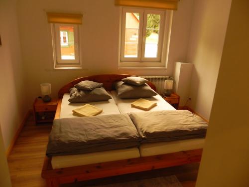 a bedroom with a bed with two pillows on it at Osada Chybotek in Przesieka