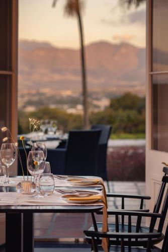 a table with wine glasses sitting on top of it at Grande Roche Hotel in Paarl