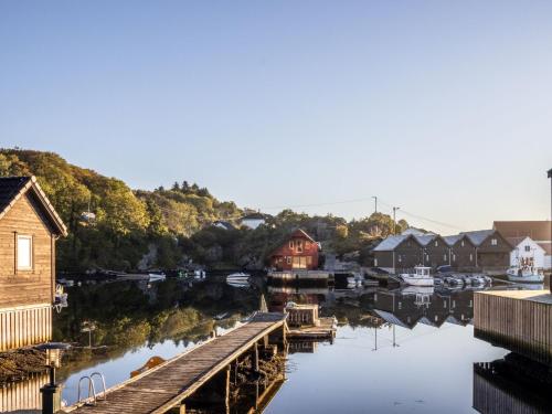 a body of water with houses and a dock at Holiday Home Nesjaholmen by Interhome in Kalavåg