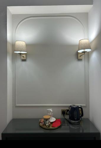 a table with two lights on top of it at Hotel Baba in Uddingston