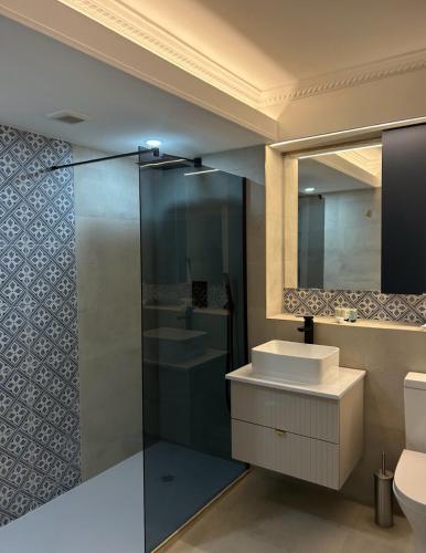 a bathroom with a sink and a mirror at Hotel Baba in Uddingston