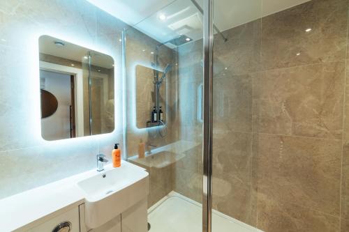 a bathroom with a shower and a sink at The Kings Head, Usk in Usk