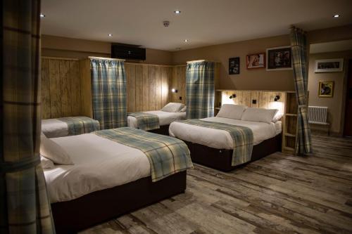 a hotel room with two beds in a room at South Causey Inn in Stanley