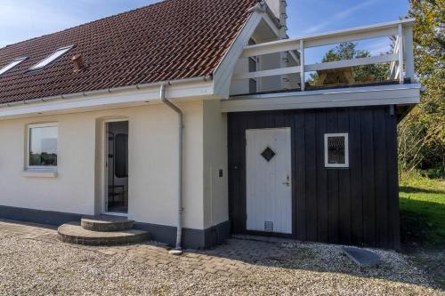 a small house with a black and white at Villa Soldal in Sindal