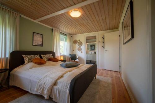 a bedroom with a large bed with pillows on it at Villa Soldal in Sindal