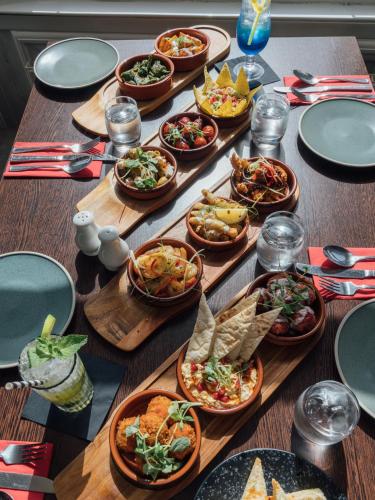 a table with many plates of food on it at Queens Hotel & Spa in Brighton & Hove