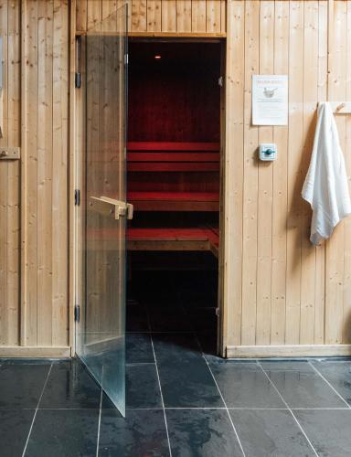 a room with wooden walls and red beds in it at Queens Hotel & Spa in Brighton & Hove
