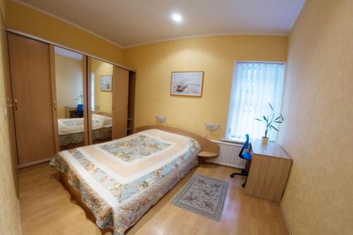 a bedroom with a large bed and a large window at Kaunas Apartments in Kaunas