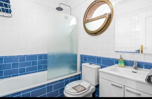 a bathroom with a toilet and a sink and a mirror at Habitación Doble con Balcon in El Médano