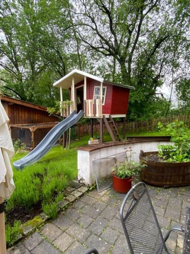 a playground with a slide and a small house at AlbPanorama Fewo mit Infrarotsauna und Gartenblick in Hohenstein