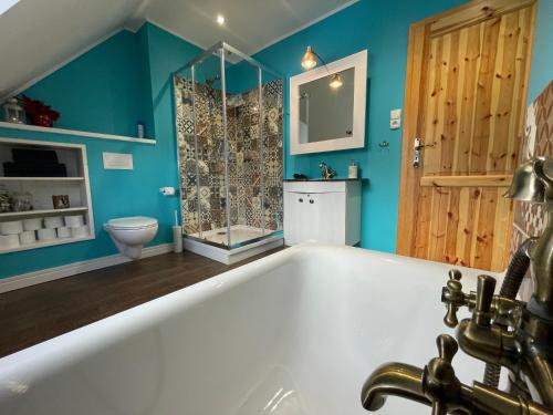 a bathroom with a bath tub and a toilet at Luxury Chalet Katarinka, Belianske Tatry in Osturňa