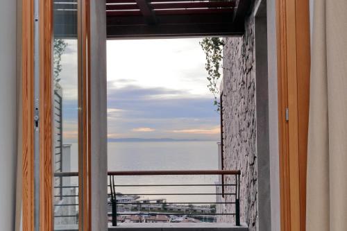 a window view of the ocean from a balcony at Portopiccolo Apartments in Sistiana