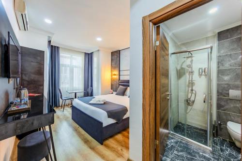 a hotel room with a bed and a shower at La Pazza Suites in Istanbul