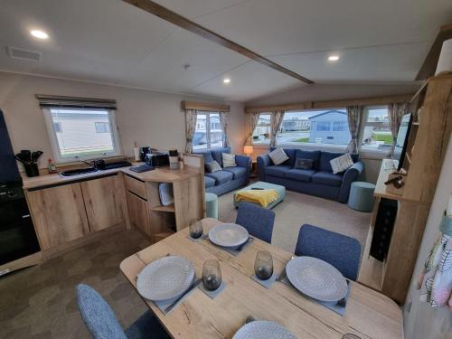 a kitchen and living room with a table and chairs at Golden Palm Resort - The Adelaide - Coastal Caravan Breaks in Skegness
