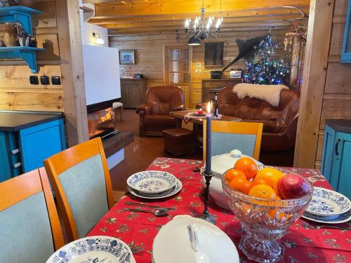 a dining room with a table with a bowl of fruit at Luxury Chalet Katarinka, Belianske Tatry in Osturňa