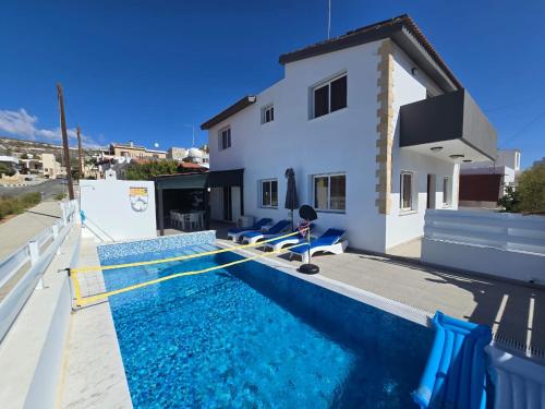 a house with a swimming pool in front of a house at Michael Angelo Villa in Paphos