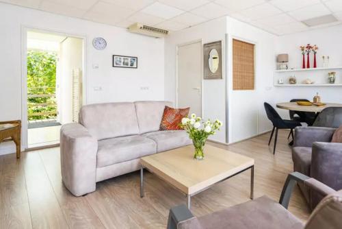 a living room with a couch and a table at Ooststraat 21 in Zoutelande