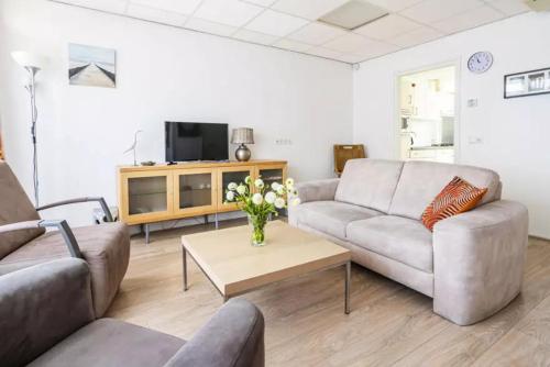 a living room with two couches and a coffee table at Ooststraat 21 in Zoutelande