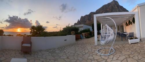 a view of a house with a patio with a umbrella at B&B Sicilia in Versi in Custonaci
