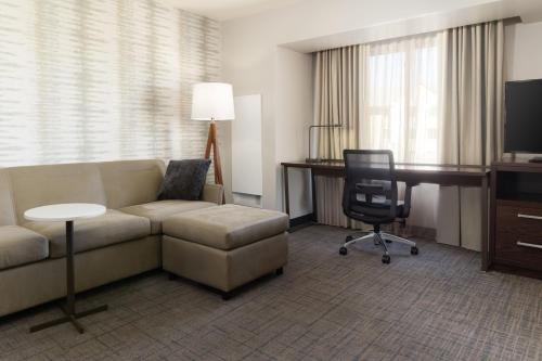 a living room with a couch and a desk and a computer at Residence Inn by Marriott Las Vegas Airport in Las Vegas