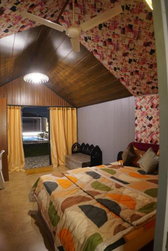 a bedroom with a large bed in a room at Great Escape Club Indore in Indore