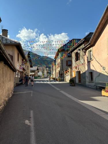 a street in a town with a mountain in the background at Appartement duplex pied des pistes et parking couvert in Arvieux
