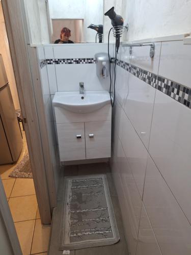a bathroom with a sink and a mirror at Homesweet in Catania