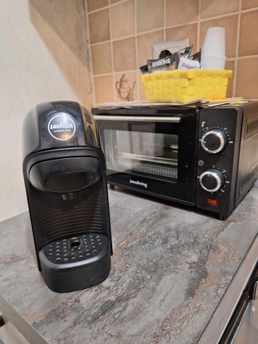 a black toaster oven sitting on top of a counter at Homesweet in Catania