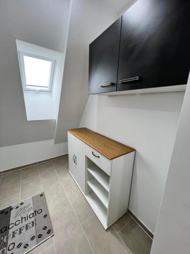 a kitchen with a counter and a black cabinet at Lippstadt Eickelborn nah der Lippe erholen! in Lippstadt