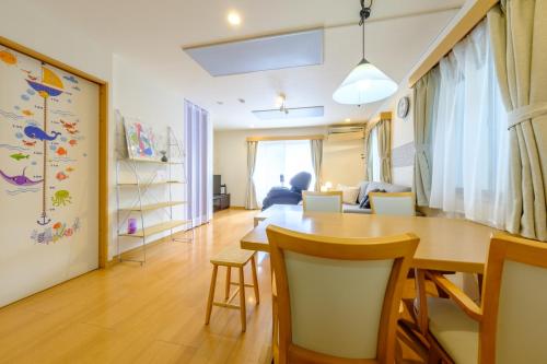 a dining room and living room with a table and chairs at Beyond Comfort 新宿大久保 - 最大10名でゆったり滞在 in Tokyo