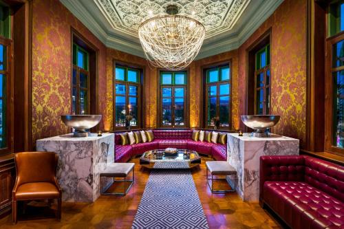 a living room with a couch and a chandelier at W Bangkok Hotel in Bangkok