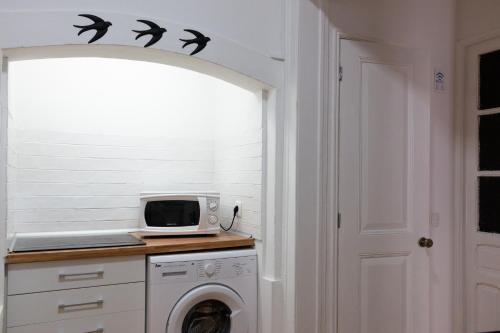 a laundry room with bats on the wall at Santos Stay by Madrabica in Lisbon