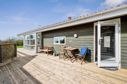 a wooden deck with a table and chairs on a house at Lovely Holiday Home On Helgenæs With Panoramic Views in Knebel
