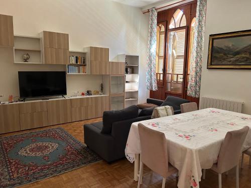 a living room with a table and a tv at Castello di Fiorano in Piacenza