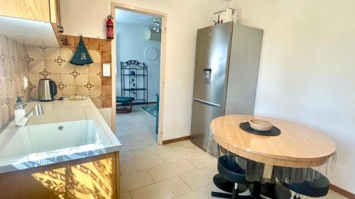 kuchnia z małym stołem i lodówką w obiekcie Rendez-vous au soleil de Provence - gite 4 personnes 80m2 - coin jardin - climatisation w mieście Cheval-Blanc