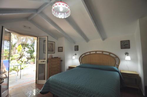 a bedroom with a bed and a chandelier at Villa Eva in Anacapri