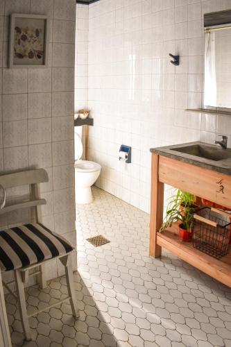 a bathroom with a sink and a toilet at Hostel Tandil in Tandil