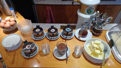 a table with several plates of food and eggs at Pension Jitka in Harrachov