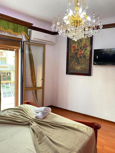 a bedroom with a chandelier and a bed at Pensione Dahab in Dahab