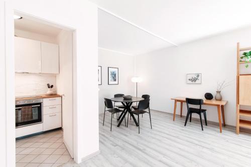 a kitchen and dining room with a table and chairs at Castagnola 501 by Quokka 360 - flat with balcony in Lugano
