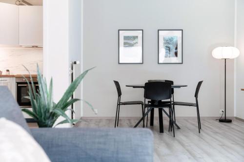 a dining room table and chairs in a living room at Castagnola 501 by Quokka 360 - flat with balcony in Lugano