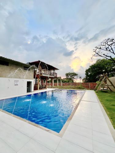 a swimming pool in the backyard of a house at Hotel Luisk Campestre in Manaure