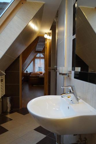 a bathroom with a sink and an attic at Willa Tatrzański Zomecek in Kościelisko